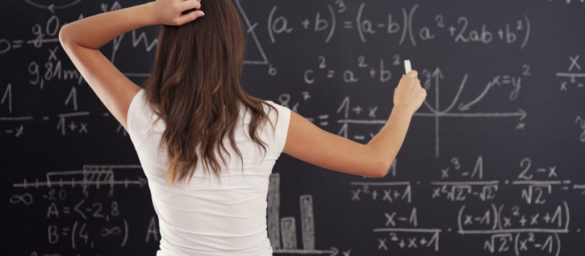 Girl Doing Math Problem On Chalkboard