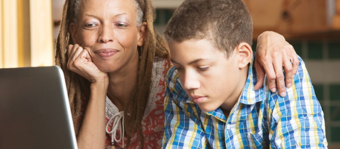 Mother And Son Using Computer